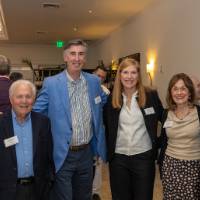 Six event guests standing together and posing for photo